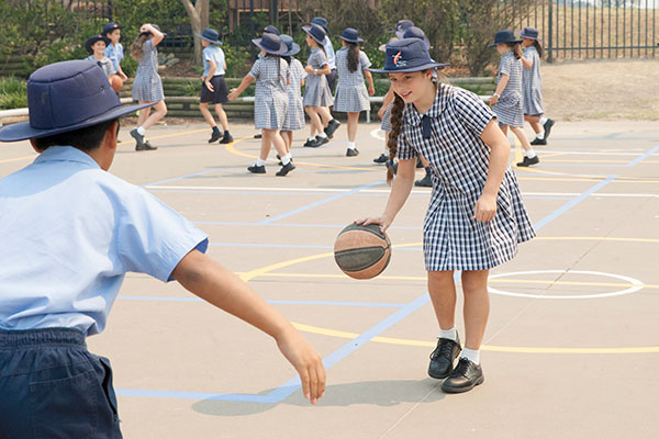Students playing basketball outdoors